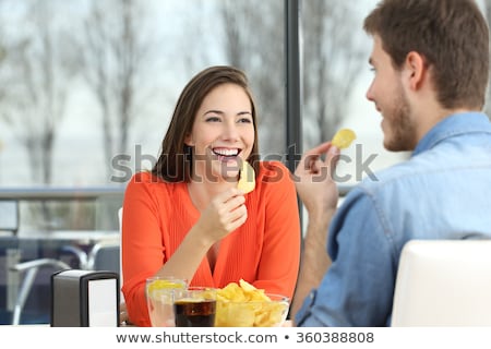 Foto d'archivio: Smiling Couple Eating Appetizers At Restaurant