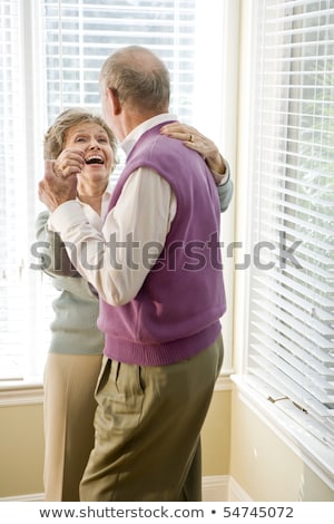 Foto stock: Rear View Of Active Senior Couple Dancing Together On The Beach