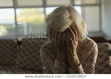 Stockfoto: Front View Of Worried Senior Woman Relaxing On Sofa In Living Room At Nursing Home