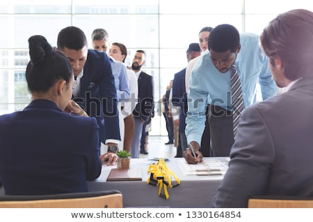 ストックフォト: Front View Of Diverse Business People Checking In At Conference Registration Table In Office Lobby