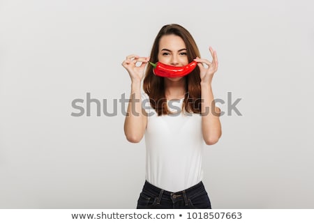 Stok fotoğraf: Biting A Red Chilli Pepper