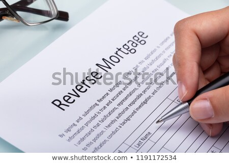 Foto d'archivio: Woman Filling Reverse Mortgage Form