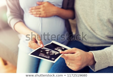 Stok fotoğraf: Close Up Of Happy Couple With Baby Ultrasound