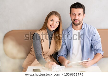 Zdjęcia stock: Small Group Of Young Successful Employees In Casualwear Working By Table In Cafe