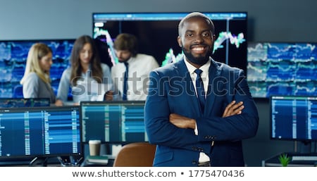 ストックフォト: African Analyst Looking At Stock Exchange Charts