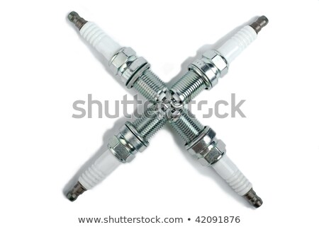 Stok fotoğraf: Four Spark Plugs In The Form Of A Cross