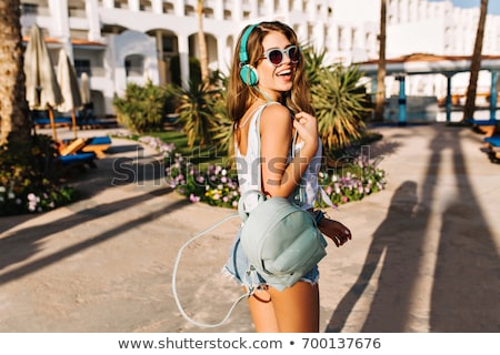 Foto stock: Portrait Of A Happy Young Woman Posing While On The Beach