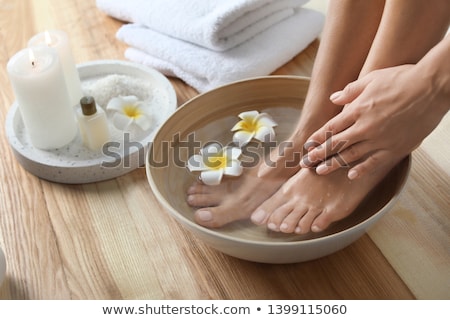 Stock photo: Woman Soaking Her Nails In Nail Bowls