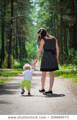 Stock photo: Mom And Son Are Walking On The Forest Road