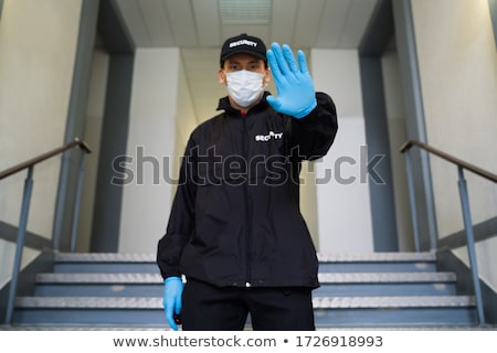 Stock fotó: Security Guard In Face Mask Making Stop Hand Gesture