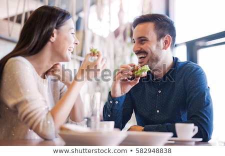 Foto d'archivio: Man And Woman Eating A Meal Together