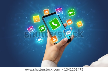 Stock foto: Hand Using Phone With Shiny Application Icons