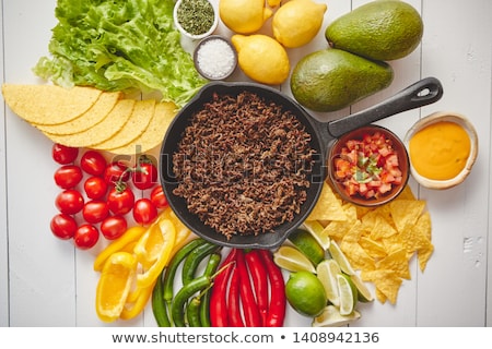 [[stock_photo]]: Ingredients For Chili Con Carne In Frying Iron Pan On White Wooden Table