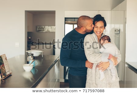 Stockfoto: Young Father Holding His Mixed Race Newborn Baby