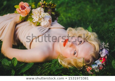 [[stock_photo]]: Bride In White Couture Wedding Dress With Flowers Posing