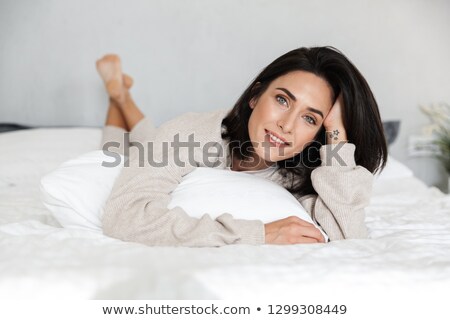 Foto stock: Beautiful Brunette Woman Lying On Sofa