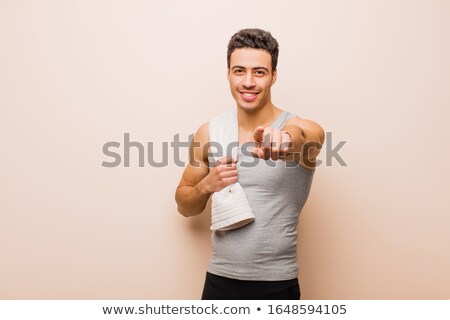 Foto d'archivio: Friendly Smiling Muscular Man Showing Direction