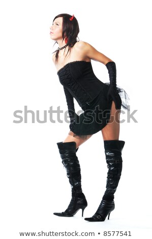 Foto d'archivio: Portrait Of An Attractive Demon Girl In Black Corset And Gloves