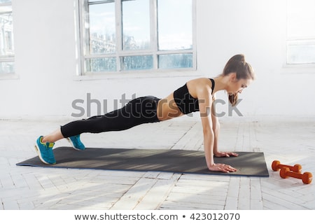 Foto stock: Beautiful Slim Brunette Doing Some Push Ups A The Gym