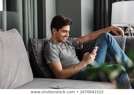 Stock fotó: Friends Using Modern Technologies In Living Room