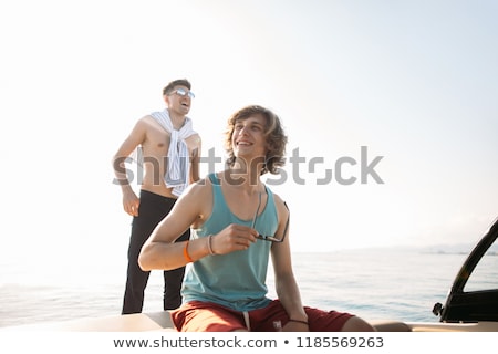 Сток-фото: Young Couple At Wheel Of Yacht In Marina