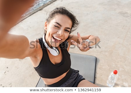 [[stock_photo]]: Cheerful Young Sportswoman Holding Water Bottle