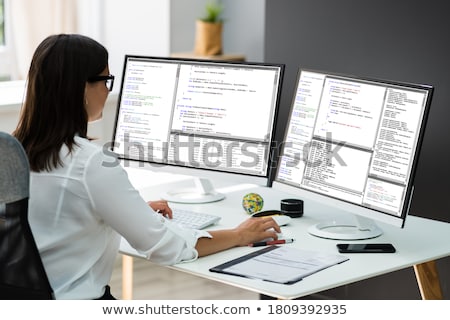 Zdjęcia stock: Developer Working On Multiple Computer Screens