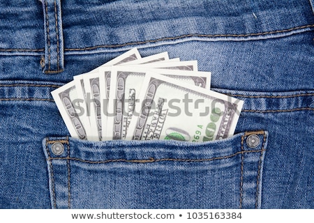 Сток-фото: A Hundred Dollar Bills Sticking In The Back Pocket Of Denim Blue