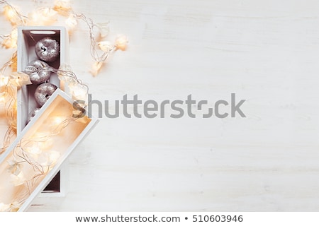 Zdjęcia stock: Christmas Soft Silver Apples And Lights Burning In Boxes On A Wooden White Background