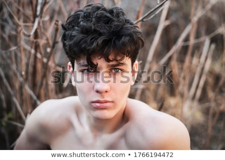 Foto d'archivio: Portrait Of A Boy With Dark Hair Outdoors