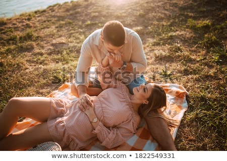 Foto stock: Young Woman With Glass Of Wine Kissing Her Man In Sunset