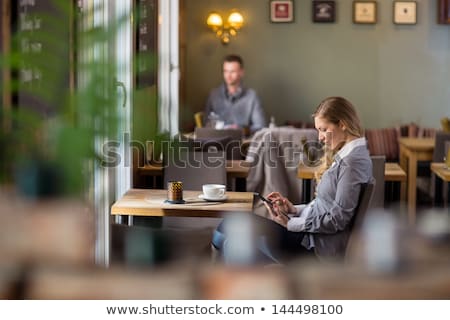 Foto d'archivio: Happy Woman With Tablet Pc At Cafe Or Coffee Shop
