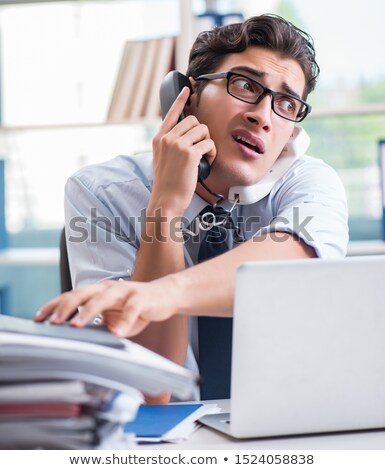 Stock fotó: Young Businessman Under Pressure In Office To Deliver Tasks