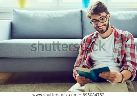 Сток-фото: Happy Man Reading Book At Home