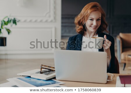 ストックフォト: Happy Young Redhead Woman Watches Training Webinar On Laptop Computer Browses Information For Proje