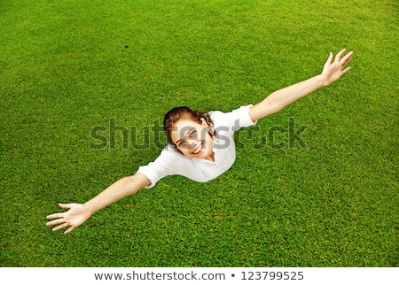 Stockfoto: Full Length Of Pretty Young Woman Resting On Grass And Smiling