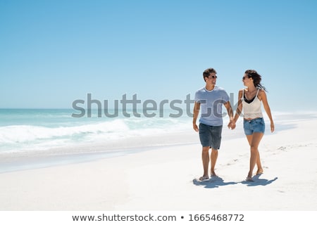 Сток-фото: Young Couple Enjoying Each Other On A Beach