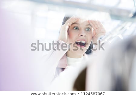 Foto stock: Young Woman Looking At Window Display