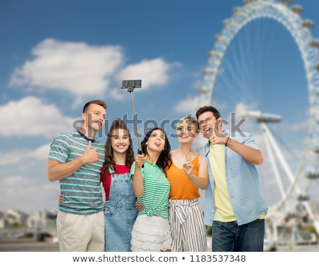 Zdjęcia stock: Friends Taking Selfie Over Ferry Wheel In London