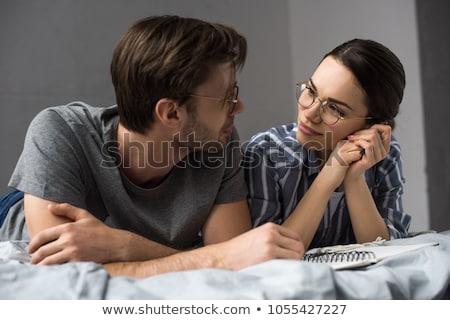 Foto d'archivio: Couple Lying On Bed Looking Each Other