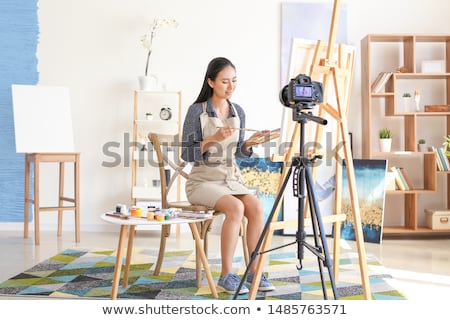 Stok fotoğraf: Asian Female Blogger With Camera Recording Video
