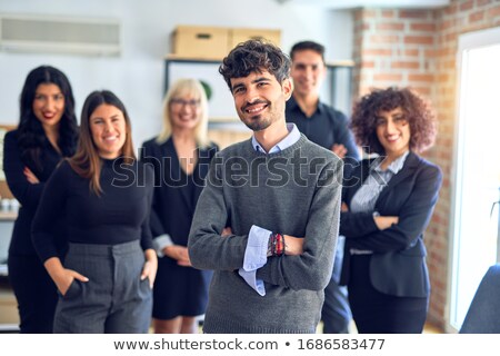 Сток-фото: Manager Relaxing In Office With Team In Background