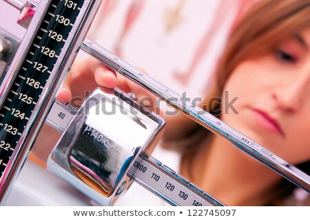 Сток-фото: Doctor With Woman On Weighing Scale