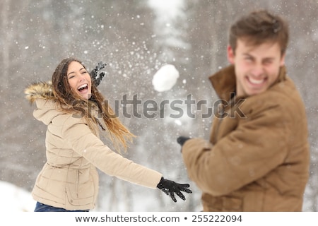 Stock fotó: Playful Young Woman Throwing A Snowball