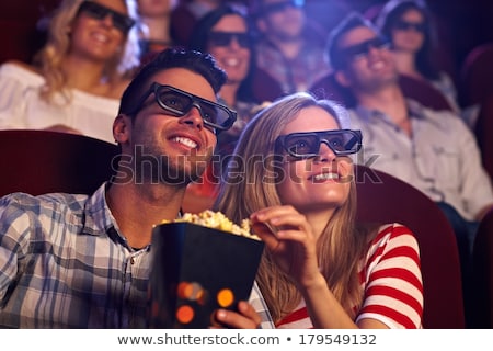 商業照片: Happy Couple Watching Movie In Theatre