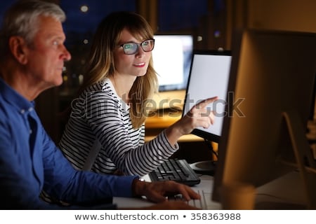 Foto stock: Creative Team With Computer Working Late At Office