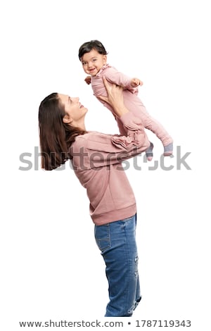 Foto d'archivio: Woman Holding Cute Daughter Posing In Studio