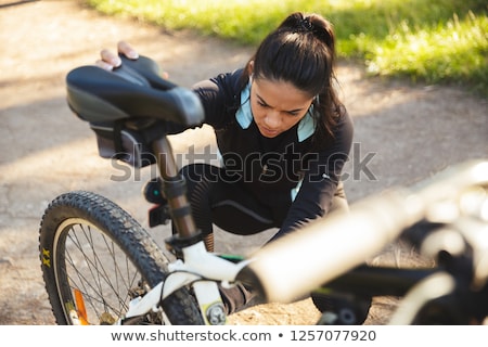 Stock foto: Attractive Fit Sportswoman With A Bicycle At The Park