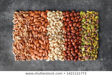 Foto stock: Various Nuts Selection On Stone Table