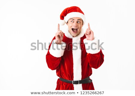 Foto stock: Portrait Of Delighted Man 30s In Santa Claus Costume And Red Hat